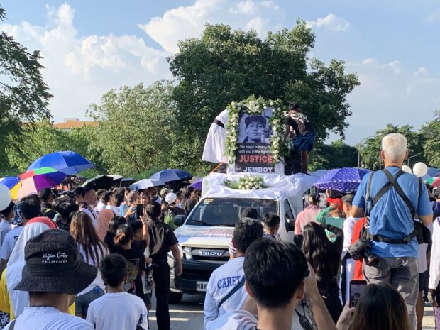 Friends and loved ones hold a funeral march to bring Jerhode Jemboy Baltazar to his resting place at the La Loma Catholic Cemetery in Caloocan City on August 16, 2023.