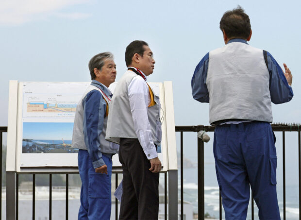 Japan's Prime Minister Fumio Kishida inspects the tsunami-crippled Fukushima Daiichi nuclear power plant in Okuma town, Fukushima, Japan