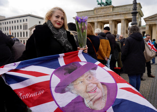 FILE PHOTO: People line up in front of Brandenburg Gate to attend the welcome ceremony for Britain's King Charles in Berlin