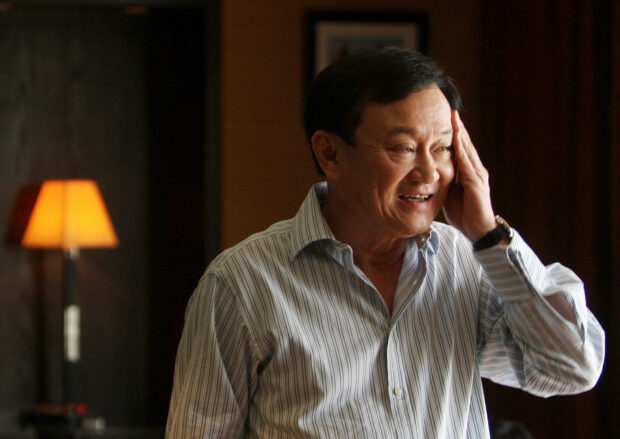 FILE PHOTO: Thailand's former prime minister Thaksin Shinawatra smiles during a meeting near his home in Dubai