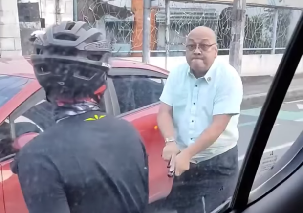 Videograb of photo showing ex-cop Wilfredo Gonzales confronting a cyclist while cocking his pistol.