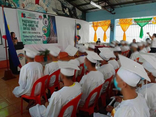 Sixty inmates in Caloocan City receive their diplomas via Alternative Learning System.