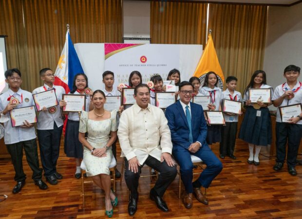 Speaker Ferdinand Martin G. Romualdez poses with Marikina Youth Leadership Award recipients Tuesday at the House of Representatives' North Lobby. 