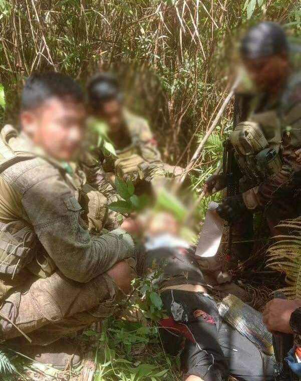 Military troops from the 53rd Infantry Battalion retrieves the remains of NPA member Edwin Gulane who was killed in a gun battle at New Rizal village, Sergio Osmeña, Zamboanga del Norte on Wednesday morning.