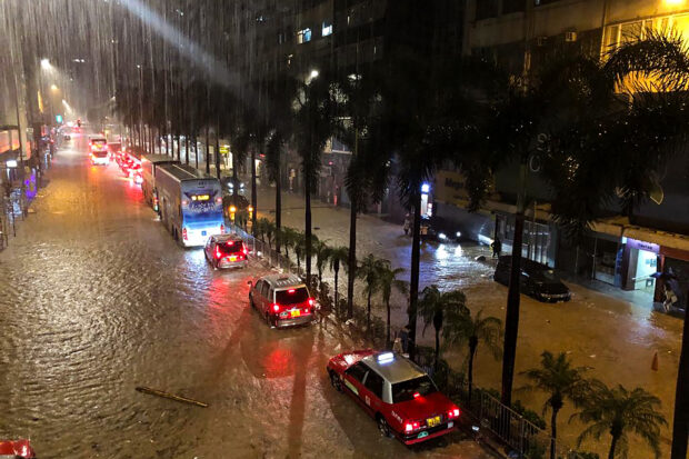 A general view of a flooded street after heavy rainstorms triggered a 'Black Rainstorm Warning' from the city’s weather observatory, in Hong Kong on September 7, 2023. (Photo by Matt Surrusco / AFP)