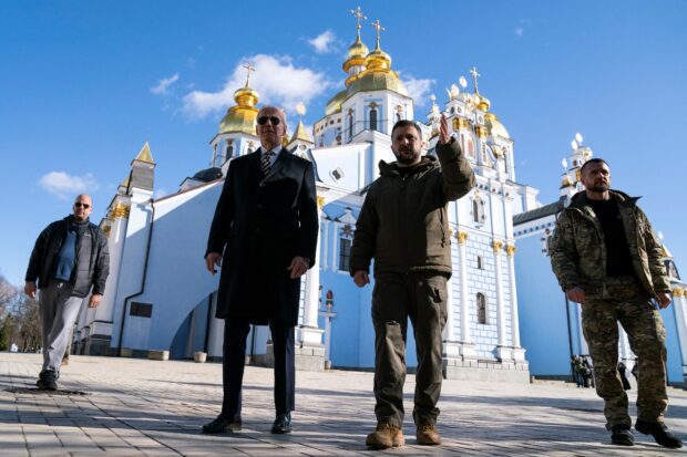  US President Joe Biden (L) walks with Ukrainian President Volodymyr Zelensky (R) at St. Michael's Golden-Domed Cathedral during an unannounced visit in Kyiv on February 20, 2023. With its war zone imagery and macho voiceover it could be a movie trailer -- but the sunglasses-clad star of a new campaign ad is none other than 80-year-old US President Joe Biden. Facing a battle in the opinion polls, America's oldest ever commander-in-chief is using his surprise trip to Kyiv in February to sell himself as a "true leader" ahead of the 2024 election. (Photo by Evan Vucci / POOL / AFP)