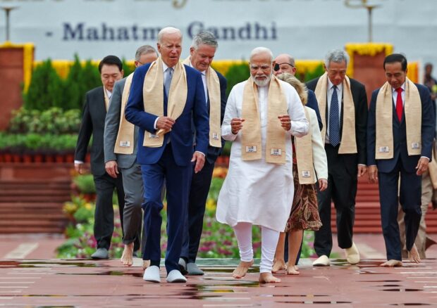 World leaders walked barefoot through puddles on Sunday to pay their respects to revered Indian independence hero Mahatma Gandhi, after monsoon downpours dampened Prime Minister Narendra Modi’s set-piece G20 program.