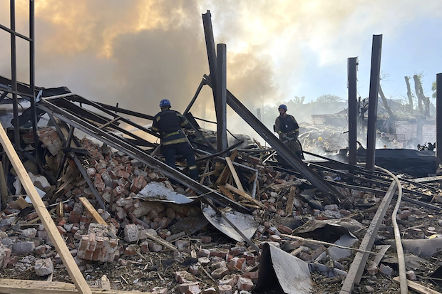 Emergency service workers fighting fire in Ukraine after Russian attack