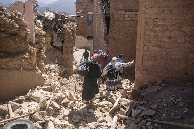 Morocco earthquake survivors walking on rubble