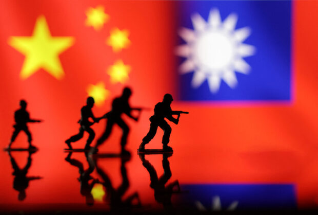 Solider miniatures are seen in front of displayed Chinese and Taiwanese flags in this illustration taken, April 11, 2023. REUTERS/Dado Ruvic/Illustration/File Photo