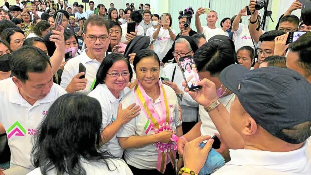 Former Vice President Leni Robredo takes photos with her supporters at the launch of nongovernment organization Angat Pampanga Association Inc. in the City of San Fernando on Sept. 2, 2023.