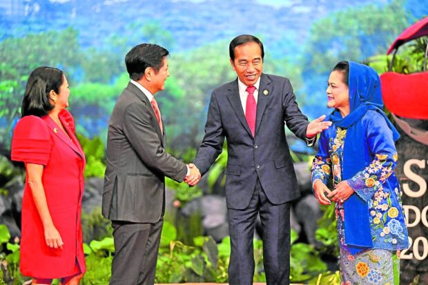 Philippines’ President Ferdinand Marcos Jr. (2nd L) and First Lady Liza Araneta Marcos (L) are welcomed by Indonesia’s President Joko Widodo (2nd R) and First Lady Iriana Widodo upon their arrival for the ASEAN Summit in Jakarta on September 5, 2023. (Photo by Adek BERRY / POOL / AFP)