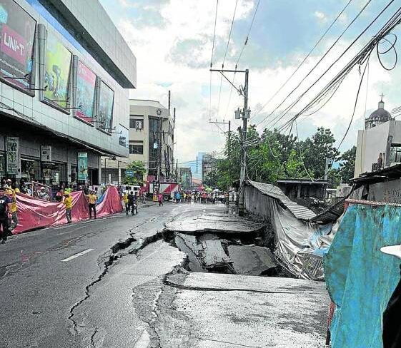 AFTERMATH A section of Legaspi Street in Cebu City caves in on Wednesday amid heavy rains and floods this week. —PHOTO COURTESY OF CEBU HILIG UG MOTO