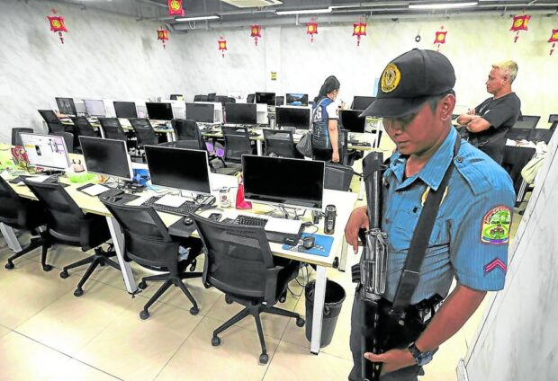 ILLEGAL ONLINE GAMBLING In this file photo, agents of the PNP Anti-Cybercrime Group inspect a gaming room, one of many at a suspected illegal Philippine offshore gaming operator’s hub in Almanza Uno, Las Piñas City. —FILE PHOTO online scams drug