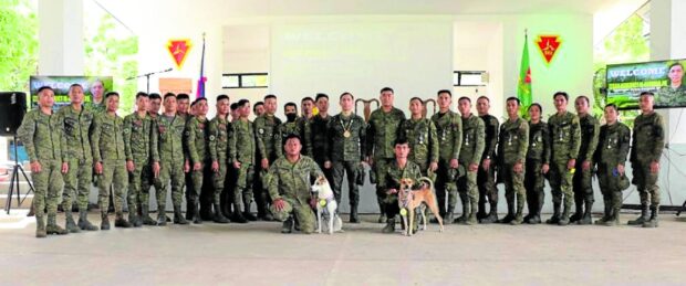 TROOPS AND TRACKERS Puti and Mugie, shown here with their Army team, were recently conferred the “Military Working Dog Achievement Medal” by Lt. Gen. Benedict Arevalo, commander of the Visayas Command (Viscom) of the Armed Forces of the Philippines, at Camp Leon Kilat in Tanjay City, Negros Oriental. —PHOTO FROM AFP-VISCOM  awards dogs