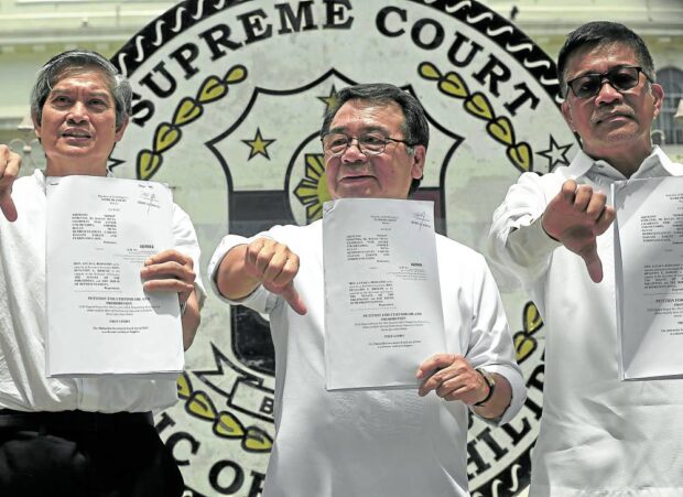 JUNK IT Bayan Muna chair Neri Colmenares (center) and former Bayan Muna Representatives Carlos Isagani Zarate (right) and Ferdinand Gaite show to reporters copies of the petition they filed in the Supreme Court to declare the Maharlika Investment Fund Act of 2023 unconstitutional. —RICHARD A. REYES 