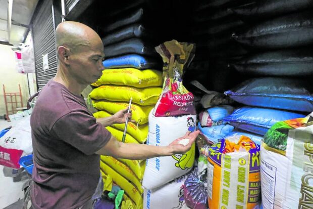 Rice retailer Eddie Pascual shows the newly harvested rice delivered to his stall in Marikina Public Market in Marikina City on Sept. 19, 2023. 