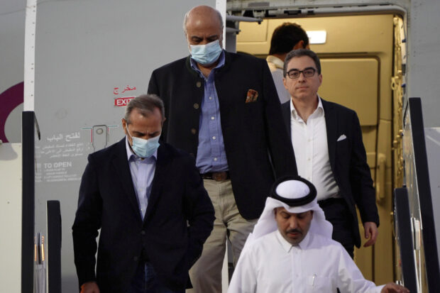 From left, Emad Sharghi, Morad Tahbaz and Siamak Namazi, former prisoners in Iran, walk out of a Qatar Airways flight that brought them out of Tehran and to Doha, Qatar, Monday, Sept. 18, 2023. 
