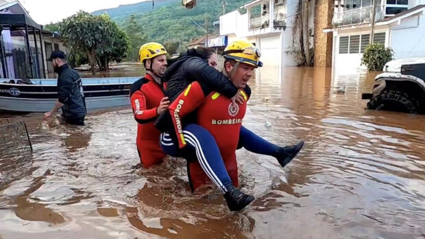 Rescuers help people amid a flood in Rio Grande Do Sul