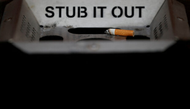 : A cigarette stub is seen in an ashtray on a street in Liverpool , northern England