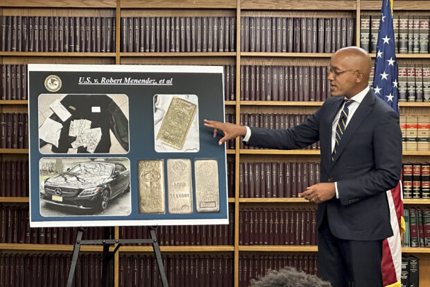 Damian Williams, U.S. Attorney for the Southern District of New York, talks about a display of photos of evidence in an indictment against Sen. Bob Menendez during a news conference, Friday, Sept. 22, 2023, in New York. 