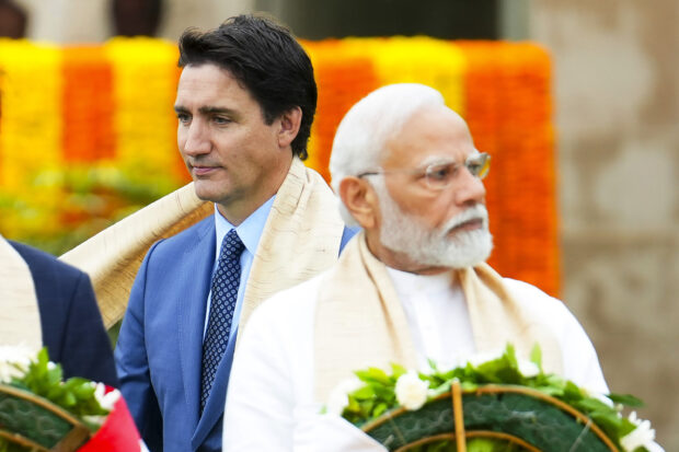 Canada's Prime Minister Justin Trudeau, left, walks past Indian Prime Minister Narendra Modi as they take part in a wreath-laying ceremony at Raj Ghat, Mahatma Gandhi's cremation site, during the G20 Summit in New Delhi, Sunday, Sept. 10, 2023. 