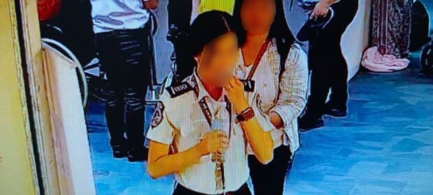 Photo of a female Naia security officer swallowing the missing $300. 