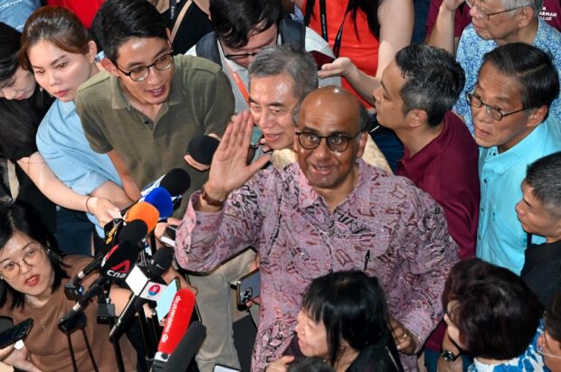 Presidential candidate Tharman Shanmugaratnam greets his supporters while waiting for the Presidential election results in Singapore on September 1, 2023. (Photo by Roslan RAHMAN / AFP)