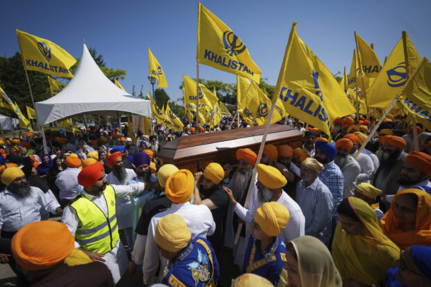 Mourners carry the casket of Sikh community leader and temple president Hardeep Singh Nijjar during Antim Darshan, the first part of a day-long funeral service for him, in Surrey, British Columbia, Sunday, June 25, 2023.
