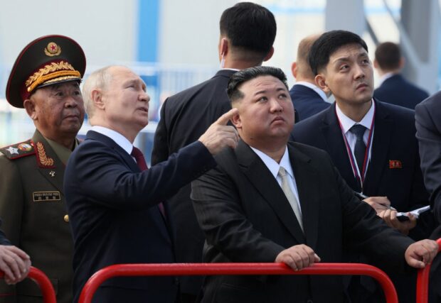 In this pool photo distributed by Sputnik agency, Russia's President Vladimir Putin (centre L) and North Korea's leader Kim Jong Un (centre R) visit the Vostochny Cosmodrome in Amur region on September 13, 2023. 