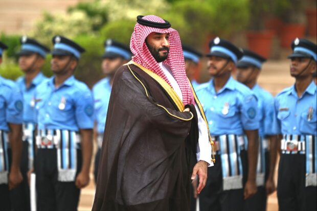 Saudi Arabia's Crown Prince and Prime Minister Mohammed bin Salman (C) inspects a guard of honour during a ceremonial reception at the President House a day after the G20 summit in New Delhi on September 11, 2023. 