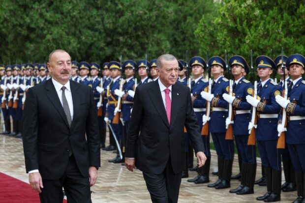 This handout photograph taken by Turkish Presidency press office on September 25, 2023, shows Turkish President Recep Tayyip Erdogan (R) inspecting the honour guard alongside Azerbaijan's President Ilham Aliyev (L)