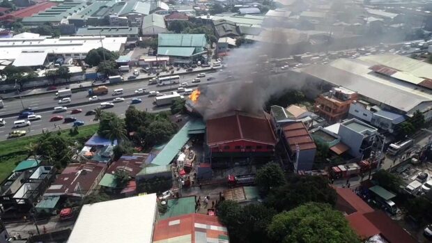 Fire burns a building in Canumay West, Caloocan city on Friday morning, September 29, 2023. 