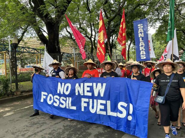 Climate activists march in the Elliptical Road in Quezon City to call for an end to fossil fuel use. Photo from Jean Mangaluz.
