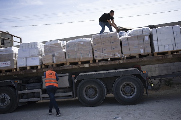 Trucks with humanitarian aid for the 'Gaza Strip enter from Egypt in Rafah on Saturday, Oct. 21, 2023. 