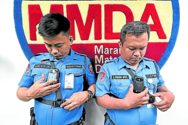 PHOTO: Traffic constables show body cameras for use in law enforcement activity. The cameras aim to prevent bribery. STORY: No Holy Week absences, leaves allowed for MMDA personnel