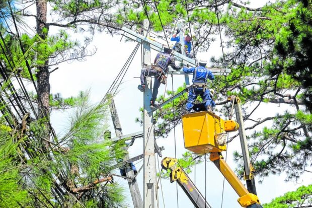 Linemen from the Benguet Electric Cooperative (Beneco) fix power lines in Baguio City in this photo taken in July 2023.