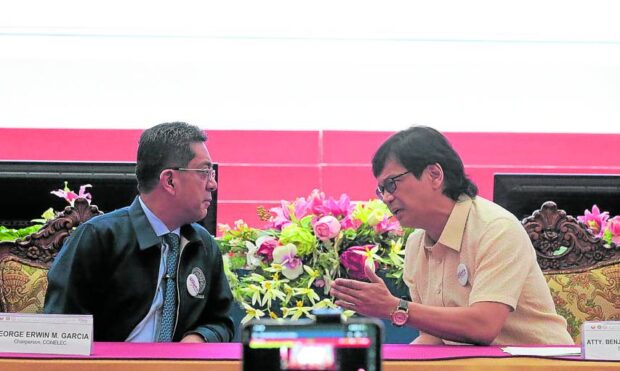 MORE IMPORTANT THINGS TO DO Interior Secretary Benjamin Abalos Jr. (right) stresses a point to Commission on Elections Chair George Garcia during a program in Quezon City on Wednesday.  —GRIG C. MONTEGRANDE