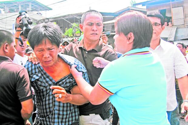 FIST OF FURY In this July 1, 2011 photo, then Davao City Mayor Sara Duterte pummels court sheriff Abe Andres as he was implementing a court order to demolish houses in a disputed property. Duterte, now the country’s Vice President, told a meeting of judges in Cebu City on Thursday that they should decide cases swiftly to prevent summary killings and street justice. —CONTRIBUTED PHOTO