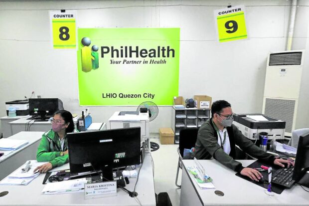  PhilHealth employees at work in Quezon City.