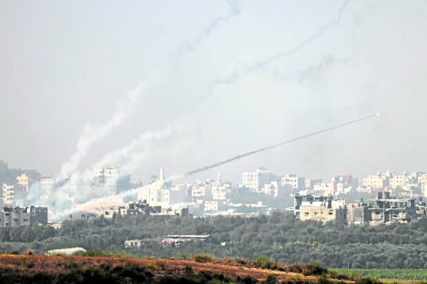 UNRELENTING  Photo taken from the southern Israeli city of Sderot shows rockets being fired toward Israel from the Gaza Strip on Oct. 23 amid ongoing battles between Israeli forces and the Palestinian Hamas group. —AFP