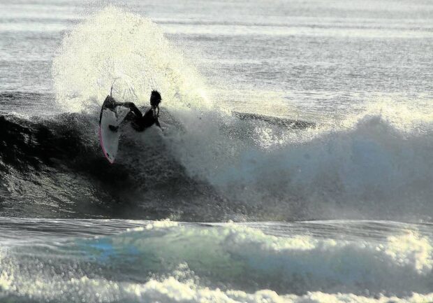 A professional surfer tests the waters off Siargao Island in Surigao del Norte