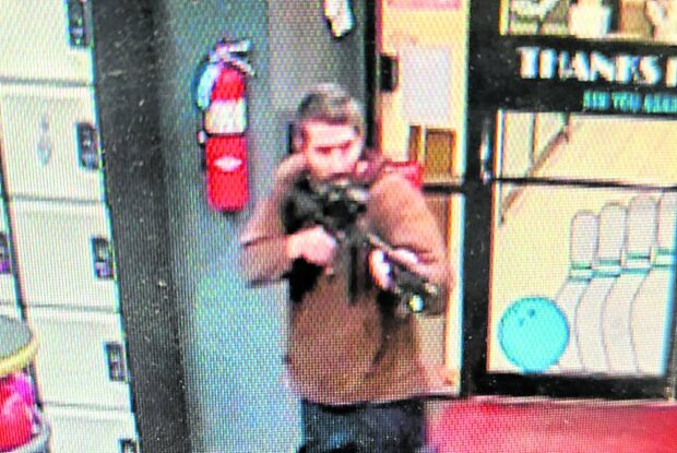 THIS YEAR’S DEADLIESTA man identified as a suspect by police points what appears to be a semiautomatic rifle, in Lewiston, Maine, on Oct. 25. Authorities said Robert Card, a certified firearms instructor and US Army reservist, fired at people upon entering a bowling alley. —Reuters