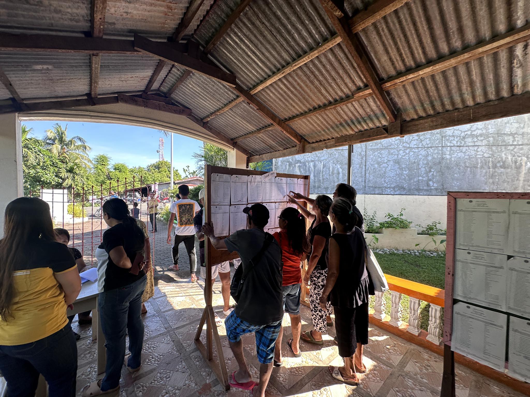 Voters in Solsona town in Ilocos Norte province search for their polling precincts during the 2023 Barangay and Sangguniang Kabataan elections on Monday, Oct. 30. 