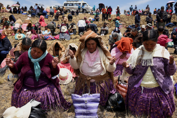 Bolivians gather at the Incachaca dam to pray for rain, on the outskirts of La Paz