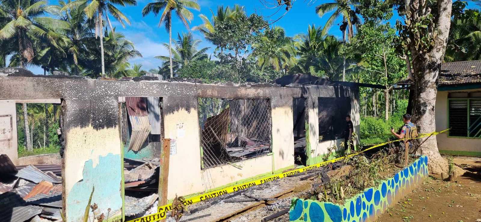 A Fire Officer of the Bureau of Fire Protection of Kauswagan, Lanao del Norte examines a building of Poona Piagapo Central Elementary School that was gutted by fire on Saturday. (Contributed photo) Two schools in Mindanao catch fire