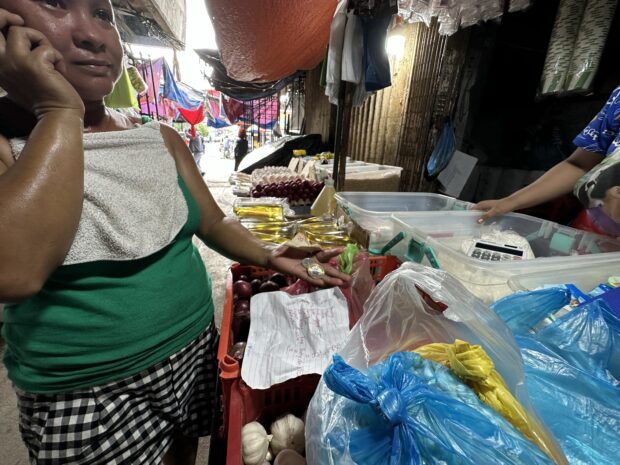 PHOTO: A consumer shows what is left of her money after getting the ingredients for a meatless ginisang bitsuelas. STORY: Inflation: Behind the numbers are real people struggling to make ends meet