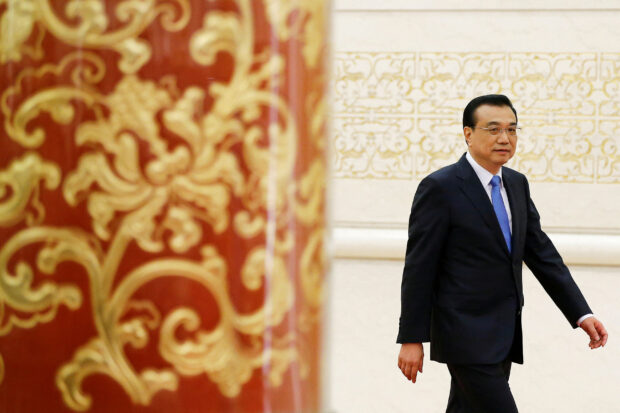 FILE PHOTO: China's Premier Li Keqiang arrives for a news conference after the closing ceremony of China's National People's Congress (NPC) at the Great Hall of the People in Beijing