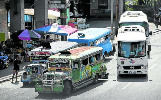 Traditional and modern jeepneys on the road.