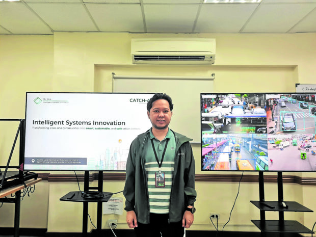 AIMING FOR ‘SMART CITIES’ De La Salle University associate professor Kerwin Billones heads the team of engineers running Catch-All, the AI-powered traffic monitoring system. —KRIXIA SUBINGSUBING